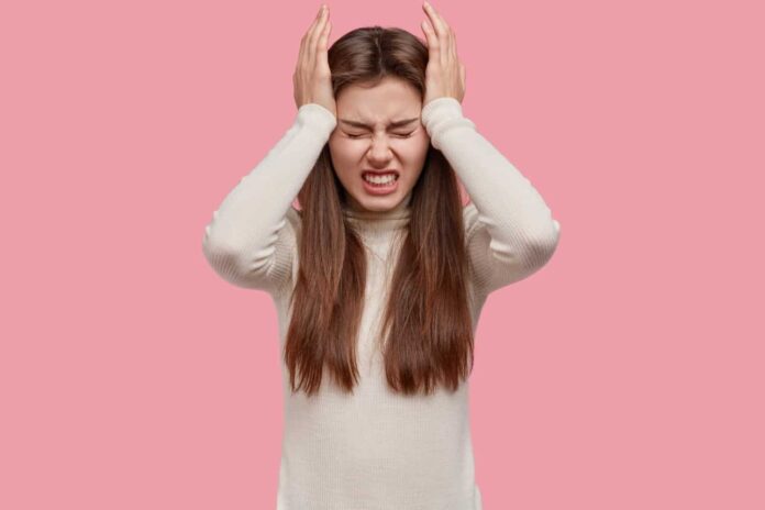 exhausted-worried-brunette-woman-keeps-hands-temples-clenches-teeth-has-headache-migraine-dressed-wh.jpeg